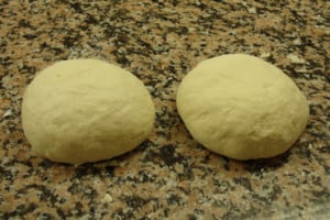 two baguette dough balls rising