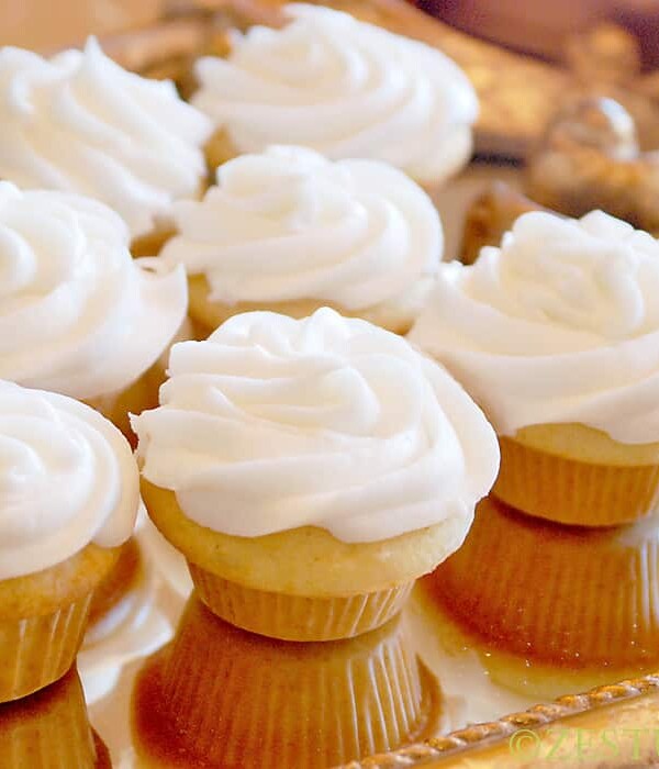 vanilla mini cupcakes with white icing on golden platter