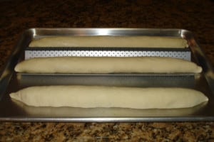 baguette dough on pan.