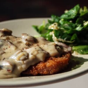 pork schnitzel with mushroom gravy and sauerkraut salad