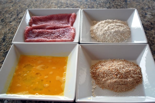 pork schnitzel ingredients in white square bowls