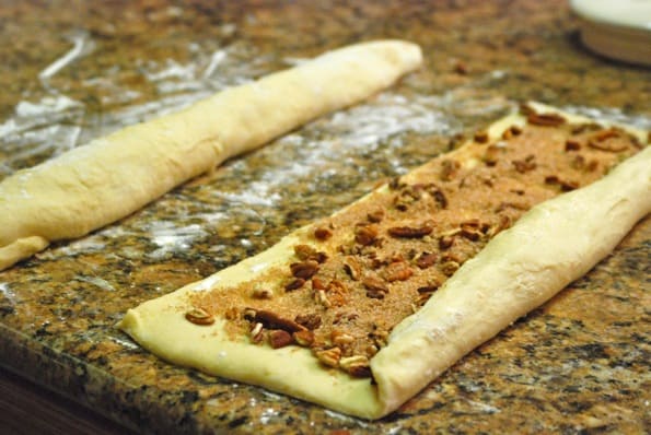 cinnamon pecan filling rolled up on counter