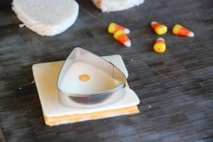 cutting cheese into candy corn shape.