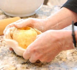 wrapping apples with dough.