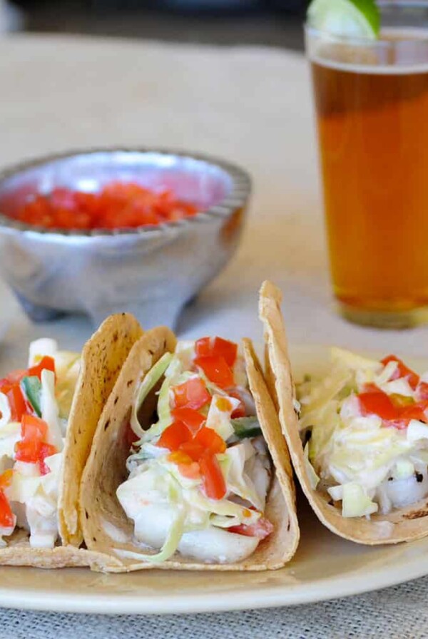 plate of grilled fish tacos with a beer.