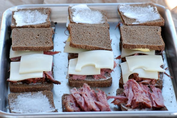 corned beef sandwiches on a baking sheet