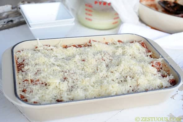 mozzarella cheese sprinkled on top of lasagna