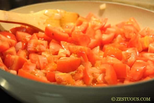 tomatoes simmering in a pan
