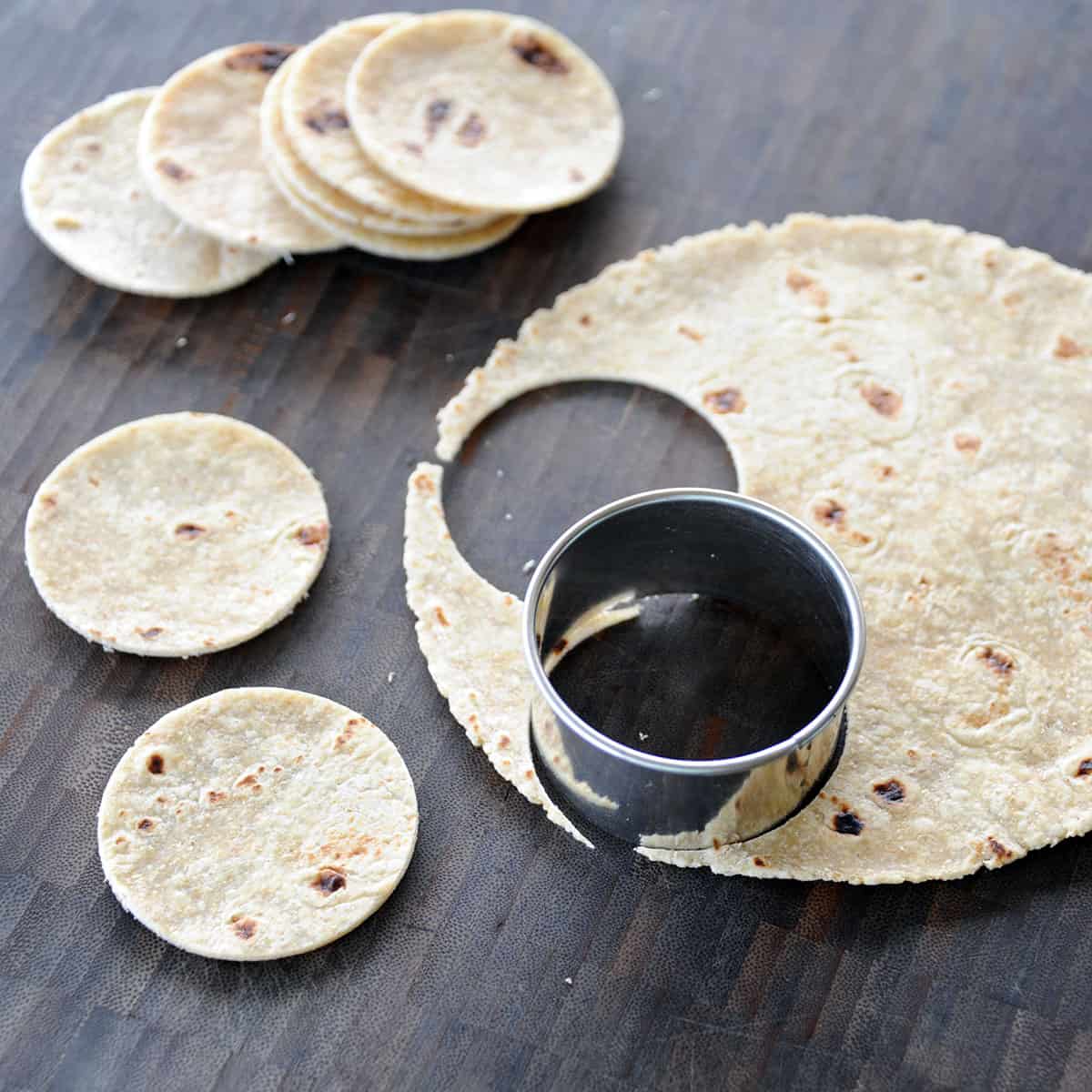 Cutting tortillas into rounds.