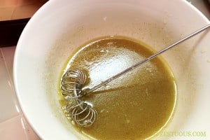 cumin vinaigrette in bowl with whisk.