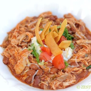 closeup bowl of chicken chili with toppings