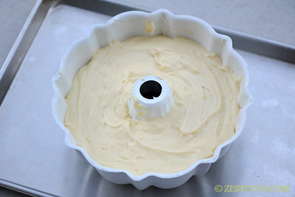 pound cake in bundt pan on cookie sheet.  Cuties (Orange) Cream Cheese Pound Cake in pan