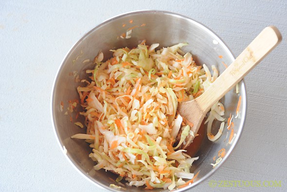 cabbage, carrots, and sriracha mixture in a bowl
