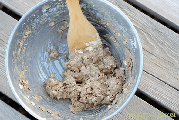 mixing bowl with wooden spoon mixing crumble topping