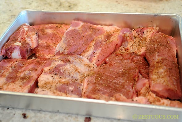 ribs close together in a pan with seasoning