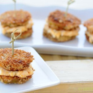 fried green tomato slices made into sandwiches with pimento cheese in the middle
