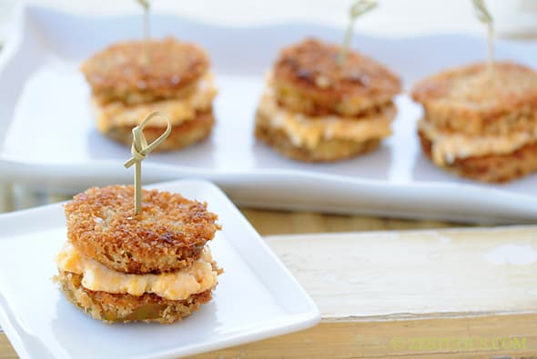 fried green tomato slices made into sandwiches with pimento cheese in the middle