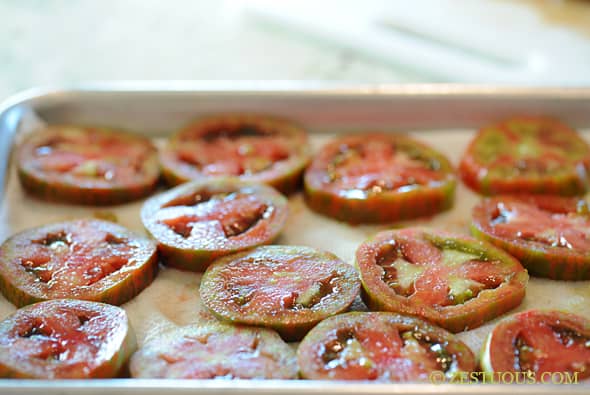 green tomato slices on a baking sheet 