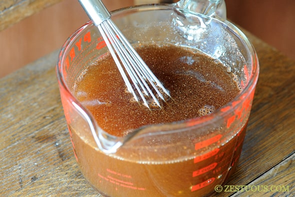 syrup in a measuring cup with a whisk