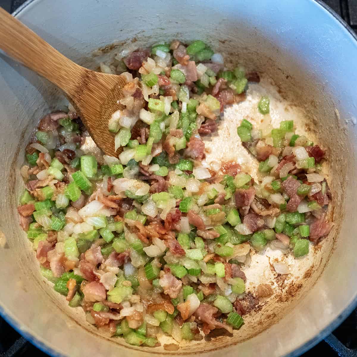 bacon, onions, celery in a pot.