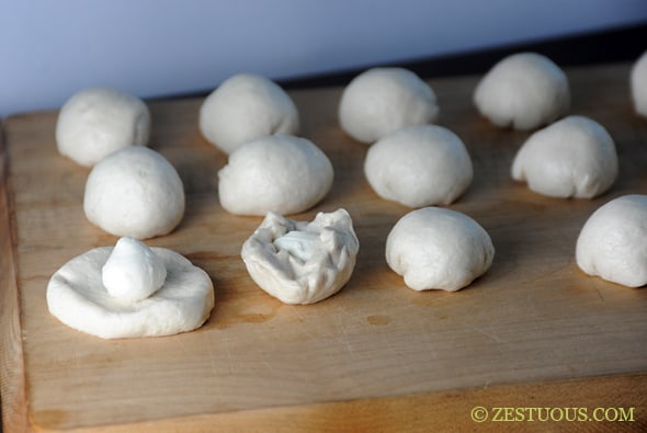 biscuits flattened with mozzarella ball on top