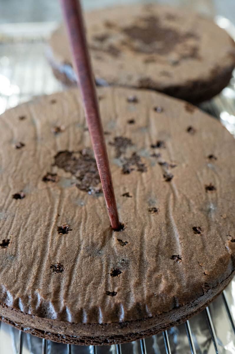 Poking holes in baked cakes.