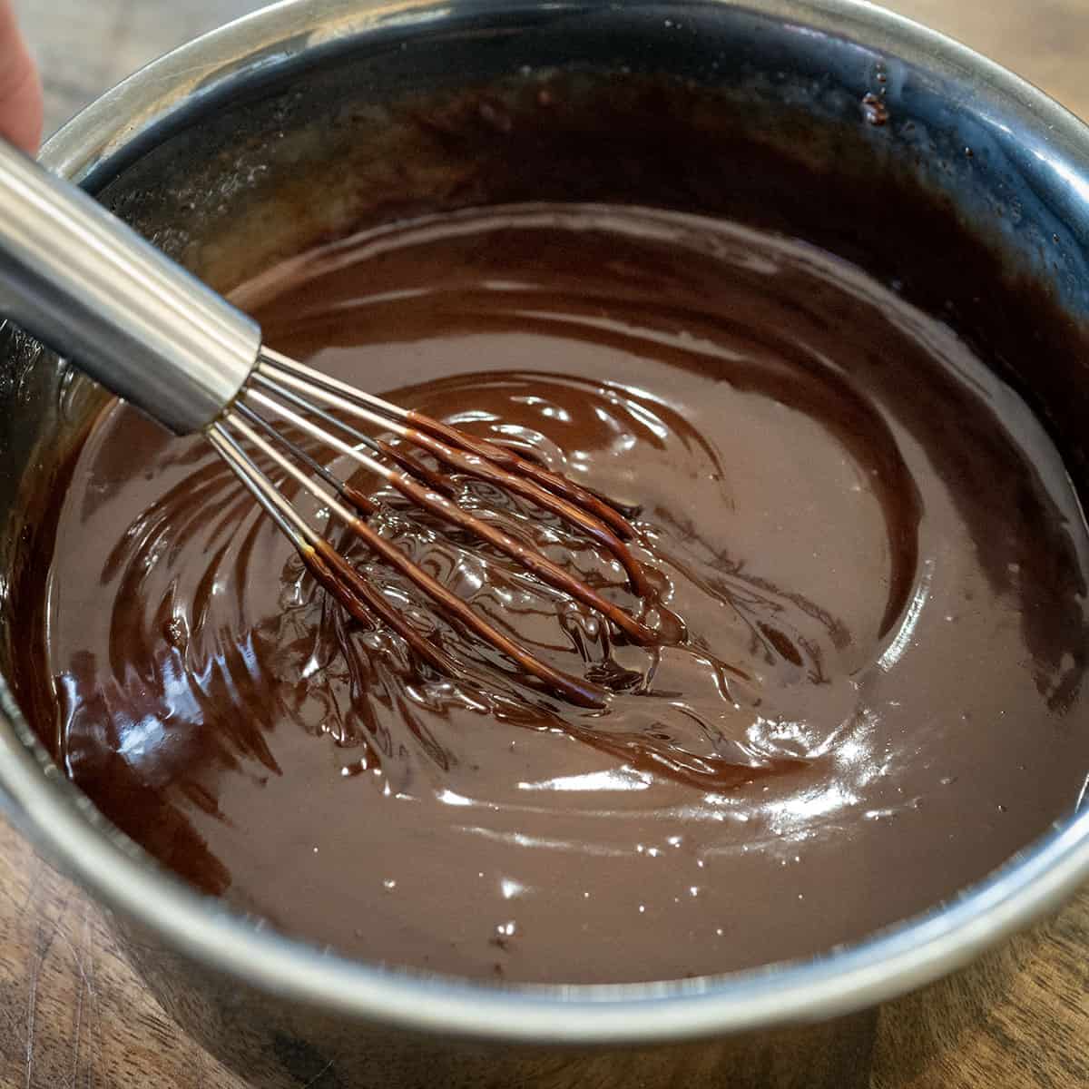 Whisking melted chocolate.